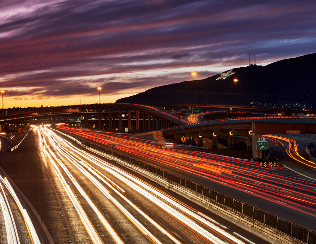 nighttime shot of highway with car lights streaked across image in El Paso Texas