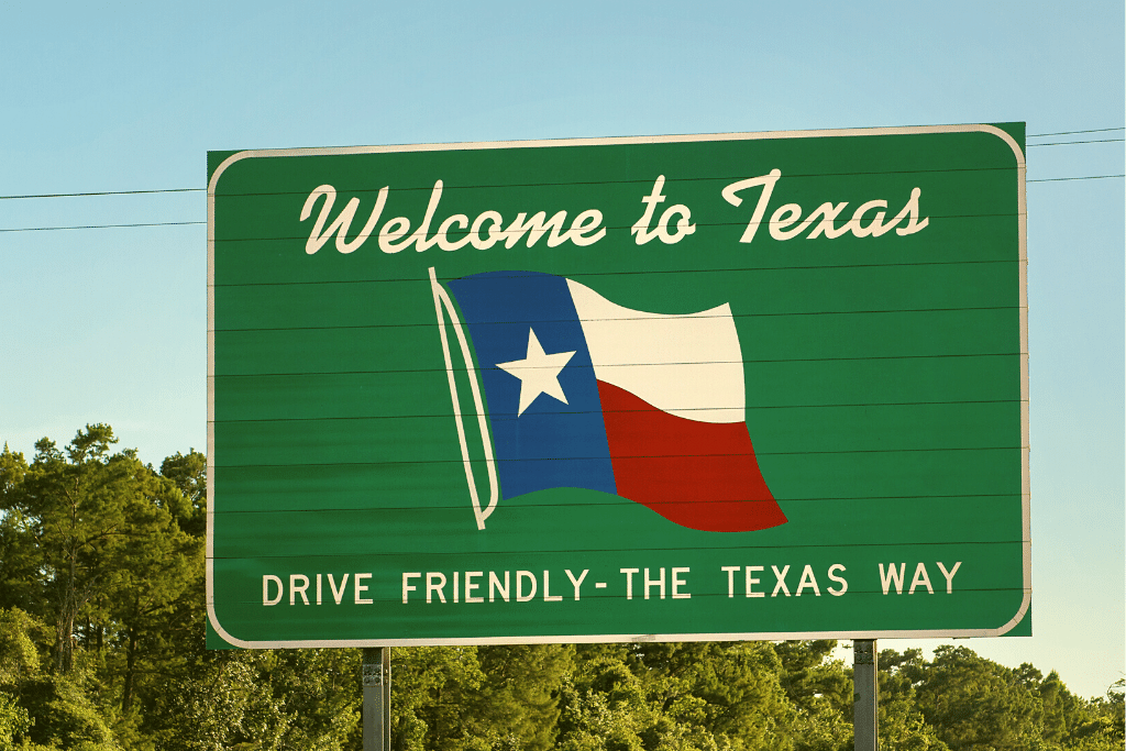 Large Highway Sign with Welcome to Texas in text and state flag of Texas.
