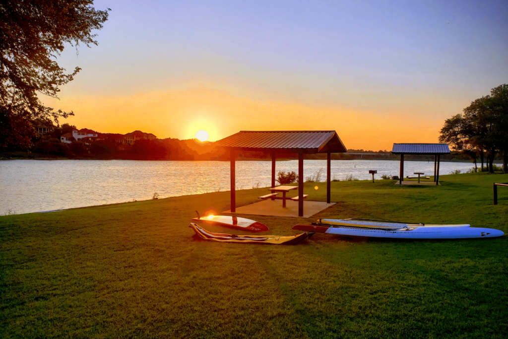 Lake at sunrise with covered picnic areas in Texas